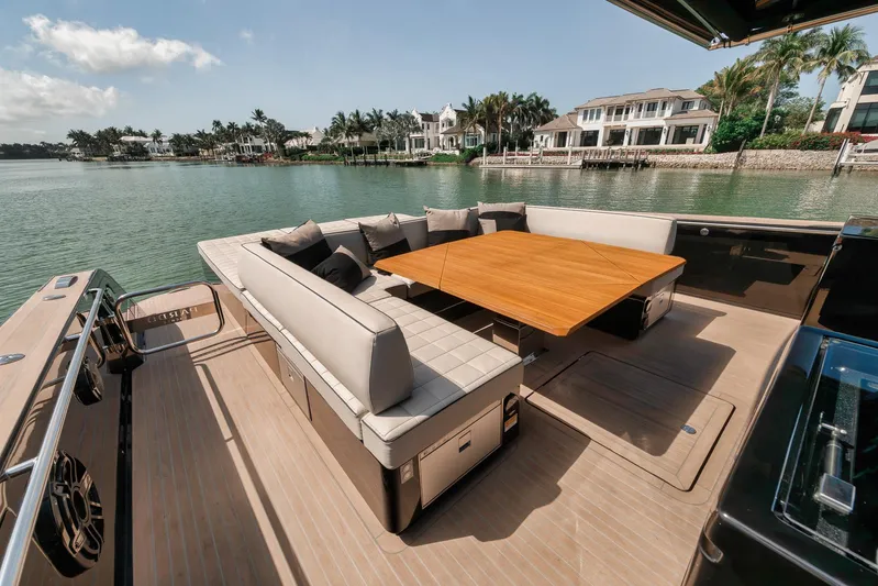 Ciao Yacht Photos Pics Luxurious 2023 Pardo Yachts 50 Pardo with elegant seating and table, docked by waterfront homes.