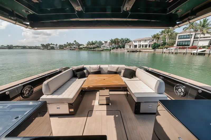 Ciao Yacht Photos Pics Luxurious 2023 Pardo Yachts 50 Pardo with elegant seating, wooden table, and scenic waterfront view.