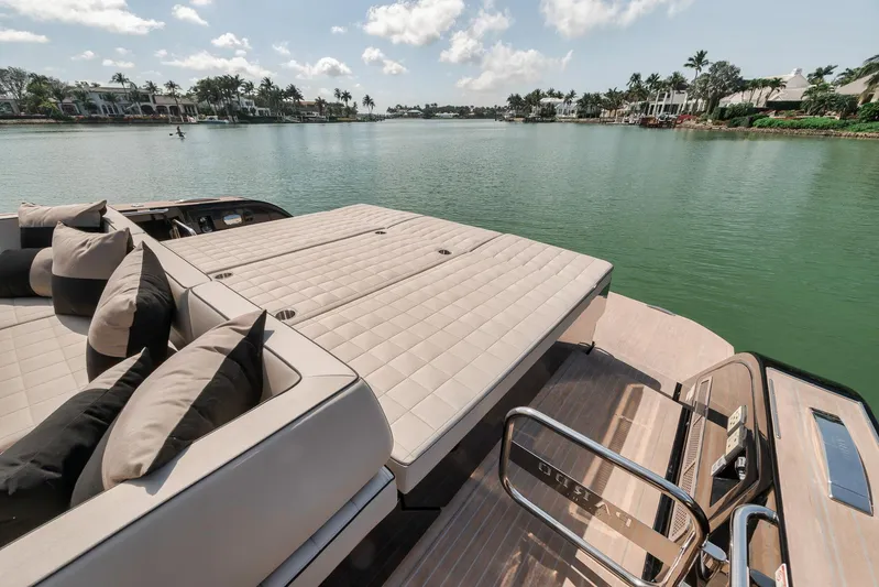 Ciao Yacht Photos Pics 2023 Pardo Yachts 50 Pardo luxury deck with cushions, overlooking serene waterfront view.