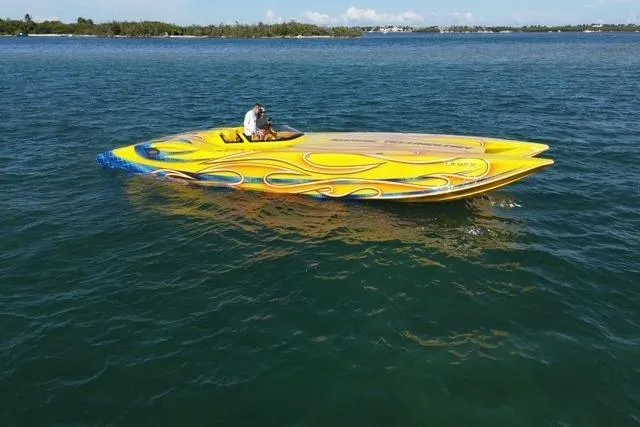  Yacht Photos Pics Yellow 2007 MTI 40RP speedboat with colorful design on calm water.