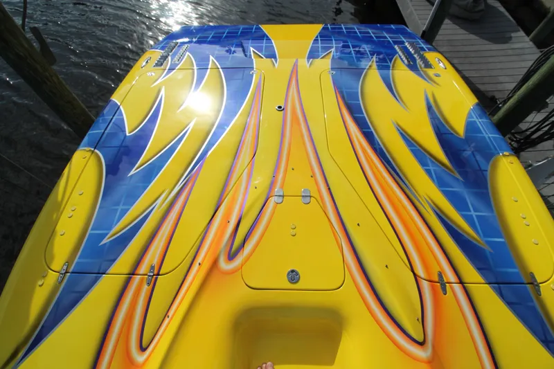  Yacht Photos Pics Colorful 2007 MTI 40RP boat with vibrant yellow, blue, and orange design.