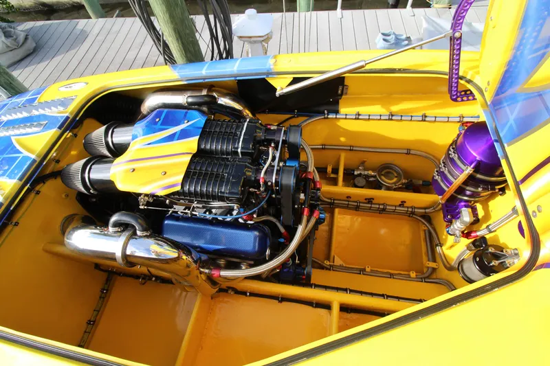  Yacht Photos Pics Engine compartment of a 2007 MTI 40RP boat, featuring vibrant yellow and blue accents.