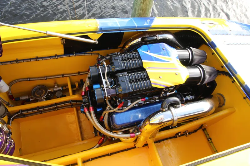  Yacht Photos Pics Engine compartment of a 2007 MTI 40RP boat, featuring a vibrant yellow and blue design.