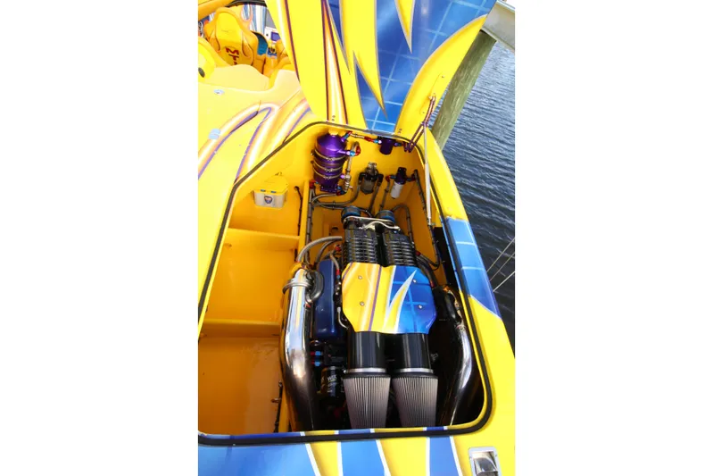  Yacht Photos Pics Engine compartment of a 2007 MTI 40RP boat with vibrant yellow and blue design.
