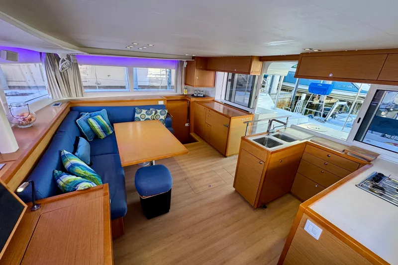 Tomcat Yacht Photos Pics Interior of 2012 Lagoon 450 F catamaran with modern kitchen and cozy seating area.