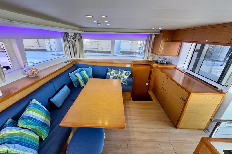 Tomcat Yacht Photos Pics Interior of 2012 Lagoon 450 F yacht with cozy seating and vibrant cushions.