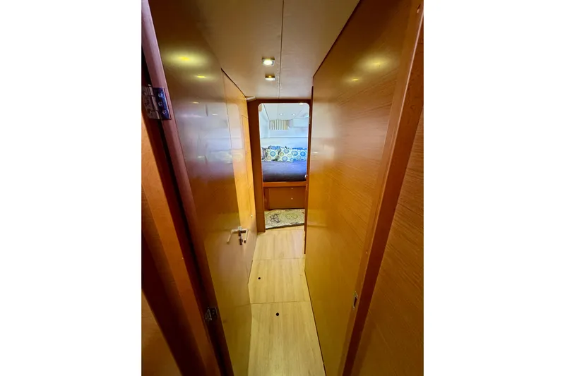 Tomcat Yacht Photos Pics Interior hallway of 2012 Lagoon 450 F catamaran, featuring wooden paneling and cozy cabin view.