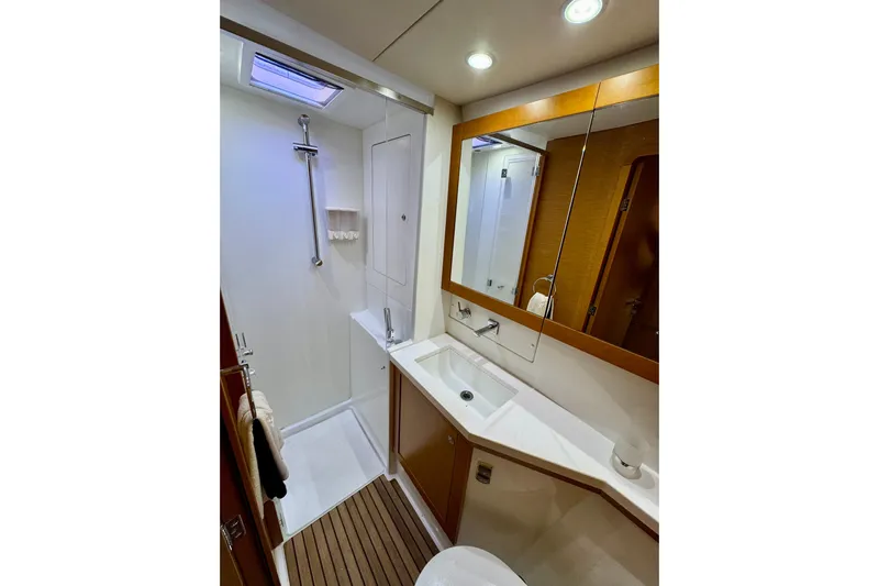 Tomcat Yacht Photos Pics Luxurious bathroom in 2012 Lagoon 450 F yacht with modern fixtures and wooden accents.