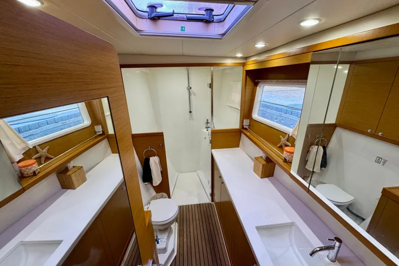 Tomcat Yacht Photos Pics Luxurious bathroom interior of 2012 Lagoon 450 F yacht with modern fixtures and wooden accents.