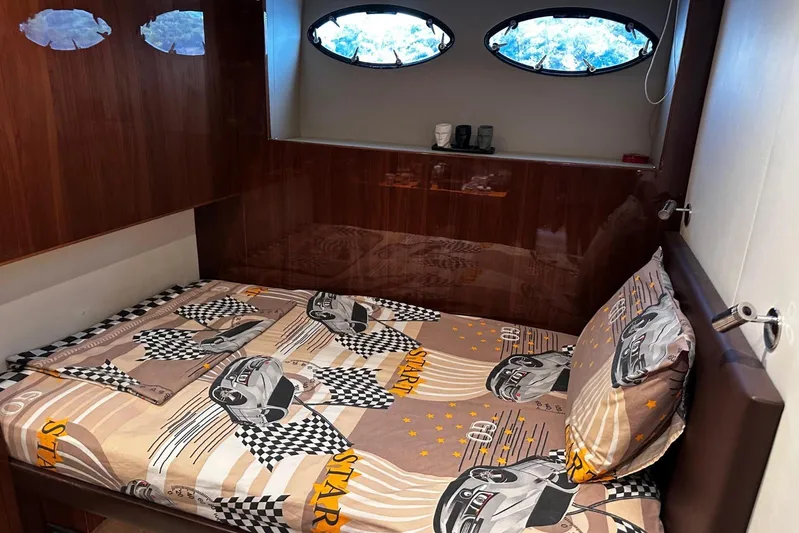  Yacht Photos Pics Luxurious cabin interior of 2016 Princess 88 Motor Yacht with race car-themed bedding.