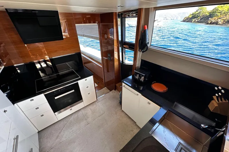  Yacht Photos Pics Luxurious kitchen interior of 2016 Princess 88 Motor Yacht with ocean view.