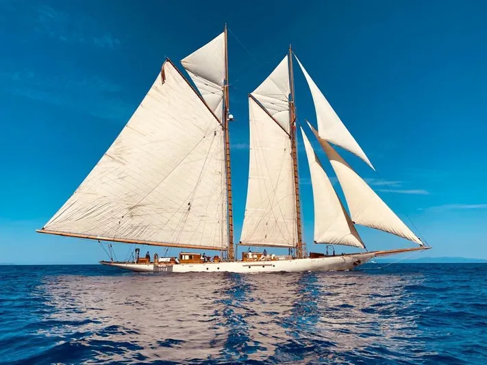 Invader Yacht Photos Pics Historic 1905 Lawley Schooner sailing on open sea under clear blue sky.