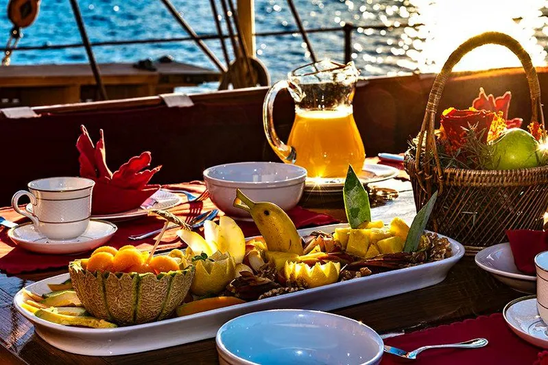 Invader Yacht Photos Pics Luxurious fruit platter and drinks on a 1905 Lawley Schooner at sunset.