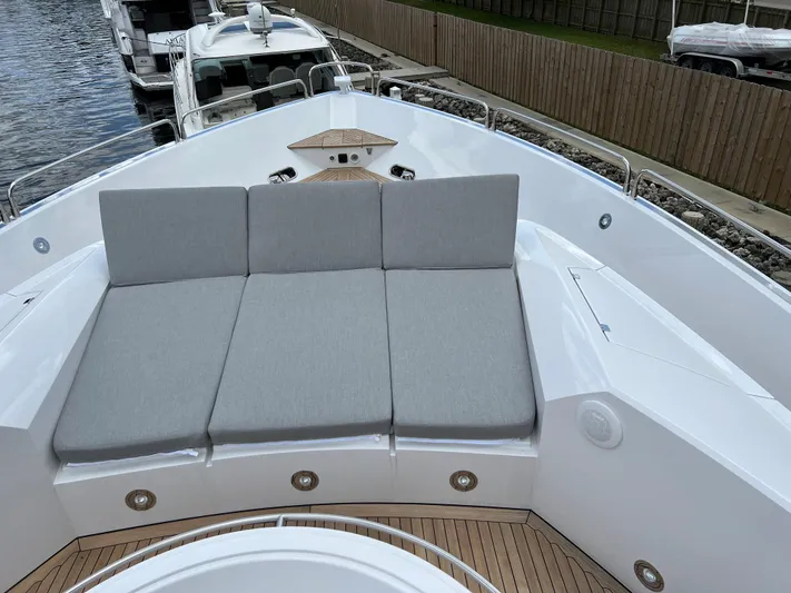  Yacht Photos Pics Sunseeker Predator 108 2007 yacht with cushioned sunbathing area on deck.
