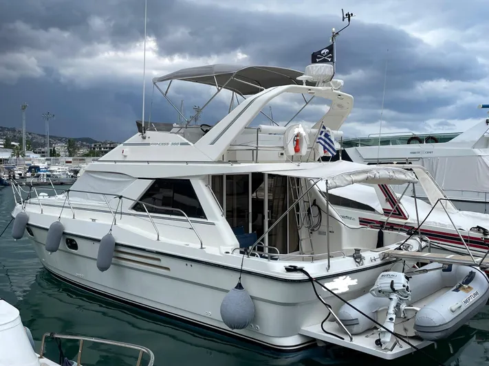  Yacht Photos Pics White 1991 Princess 388 yacht docked under cloudy skies.