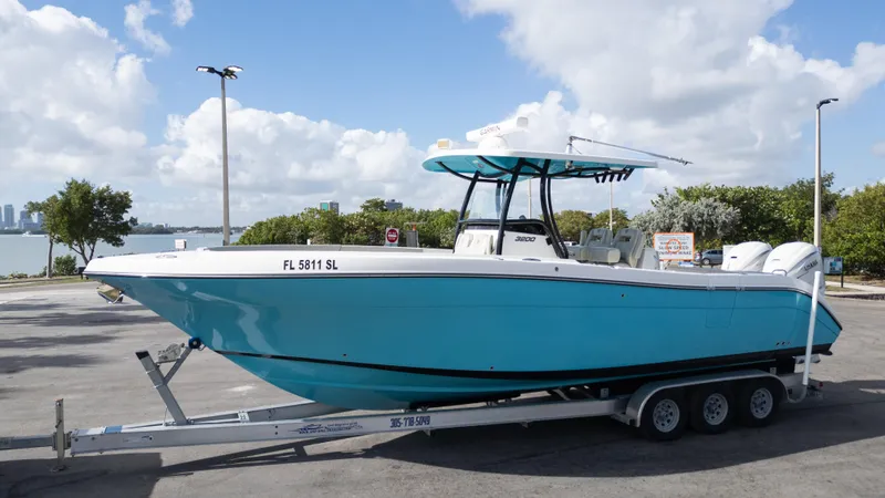  Yacht Photos Pics 2019 Century 3200 Center Console boat on trailer, parked near waterfront.