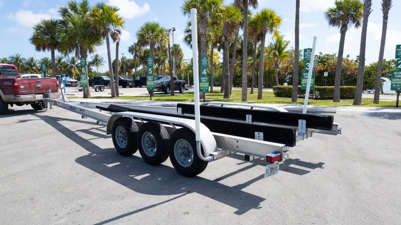  Yacht Photos Pics Triple-axle boat trailer parked near palm trees, suitable for 2019 Century 3200 Center Console.
