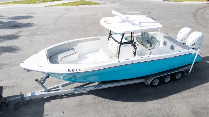 Yacht Photos Pics 2019 Century 3200 Center Console boat on trailer, featuring a sleek blue and white design.