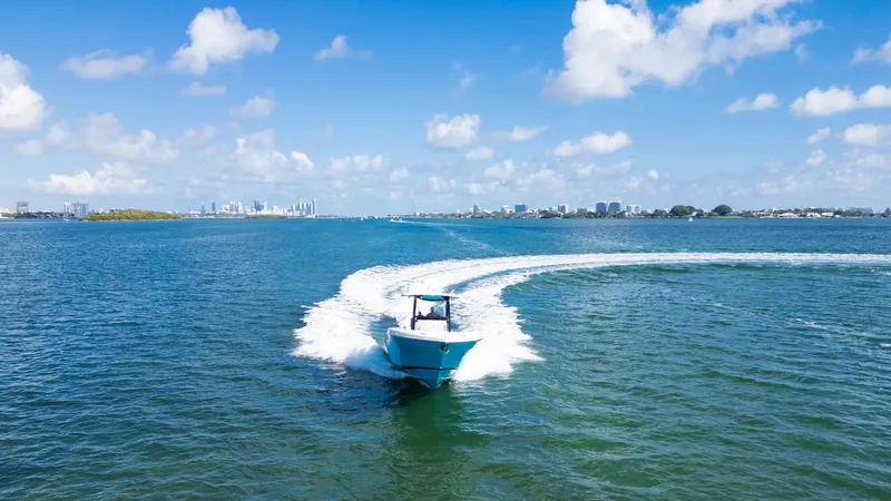  Yacht Photos Pics 2019 Century 3200 Center Console boat cruising on open water under a clear blue sky.