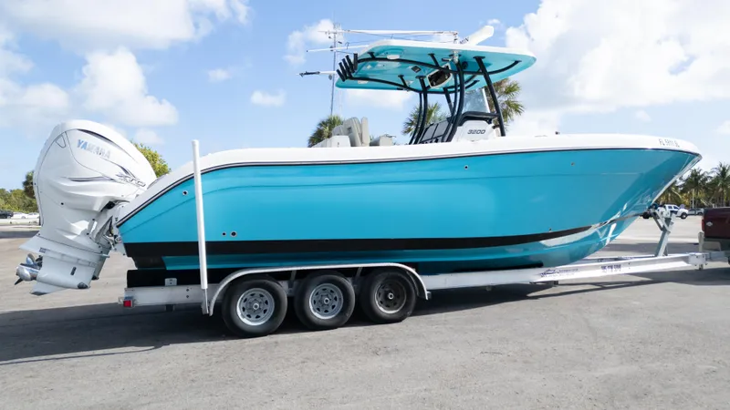  Yacht Photos Pics 2019 Century 3200 Center Console boat on trailer, vibrant blue hull, dual outboard engines.
