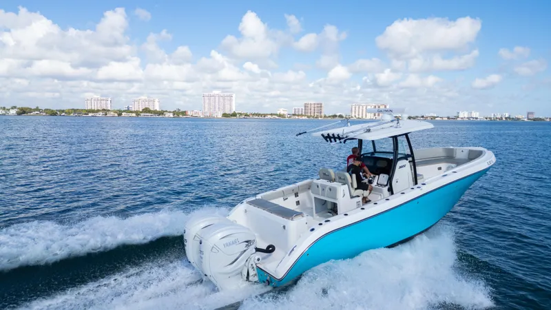  Yacht Photos Pics Century 3200 Center Console 2019 boat cruising on open water under a clear blue sky.