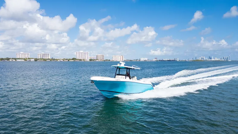  Yacht Photos Pics Century 3200 Center Console 2019 boat cruising on open water under a clear blue sky.