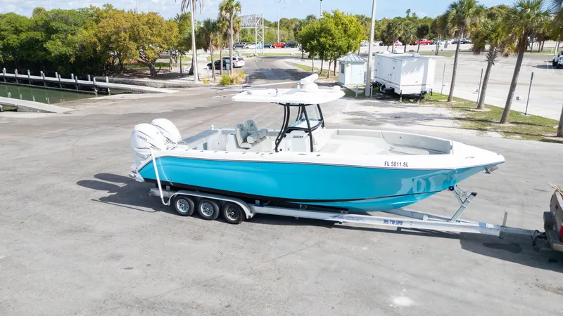  Yacht Photos Pics 2019 Century 3200 Center Console boat on trailer in sunny parking lot.