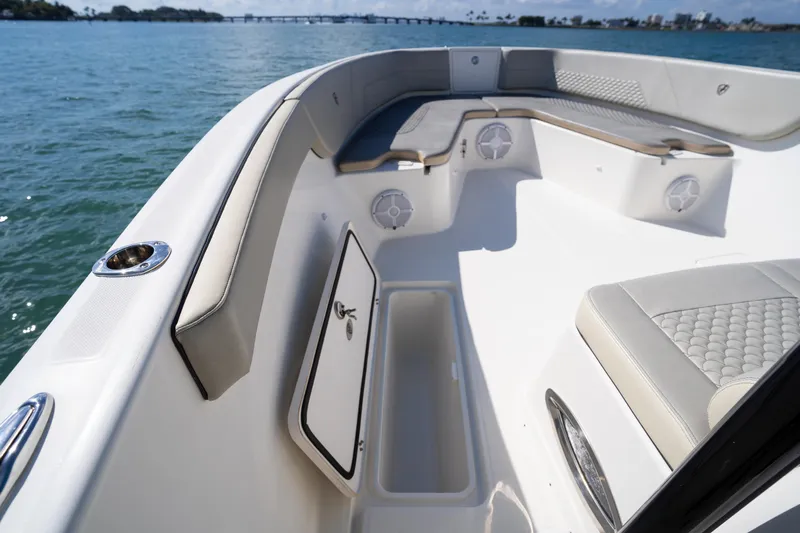  Yacht Photos Pics 2019 Century 3200 Center Console boat interior with seating and storage, on calm water.