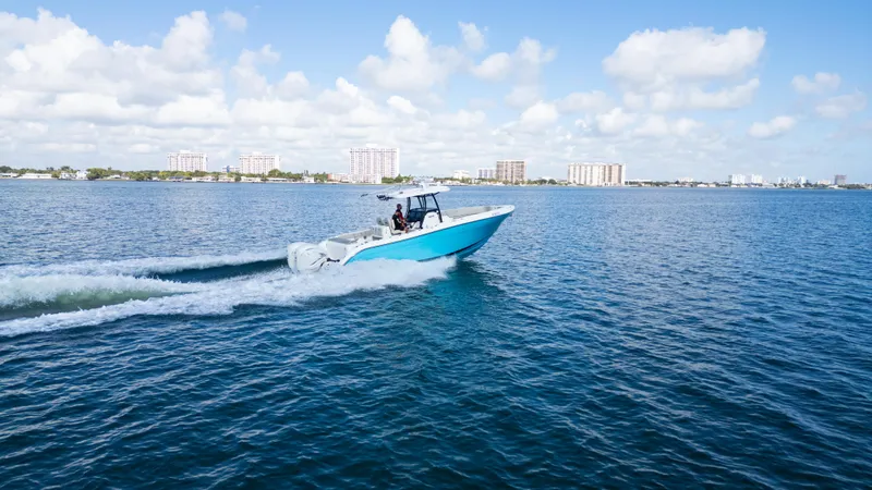  Yacht Photos Pics 2019 Century 3200 Center Console boat cruising on open water under a clear blue sky.