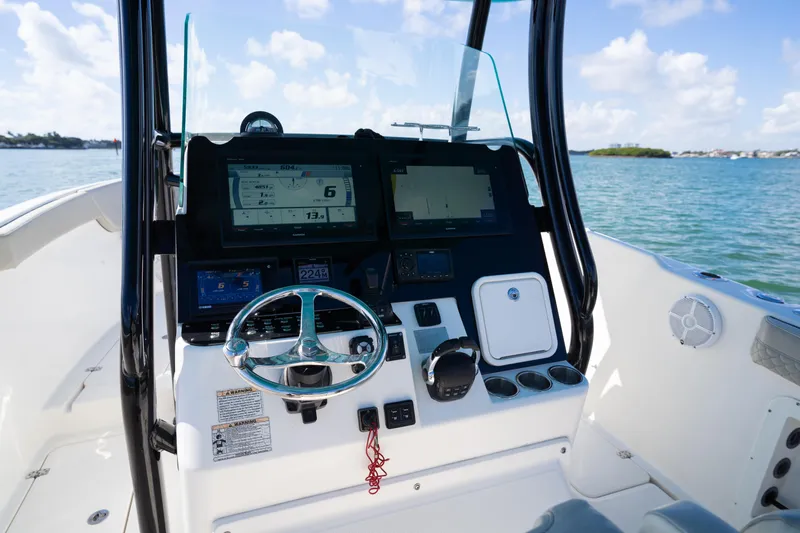  Yacht Photos Pics 2019 Century 3200 Center Console boat dashboard with steering wheel and navigation screens.