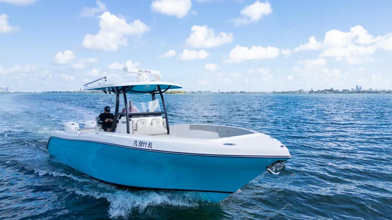  Yacht Photos Pics Century 3200 Center Console 2019 boat cruising on open water under a clear blue sky.