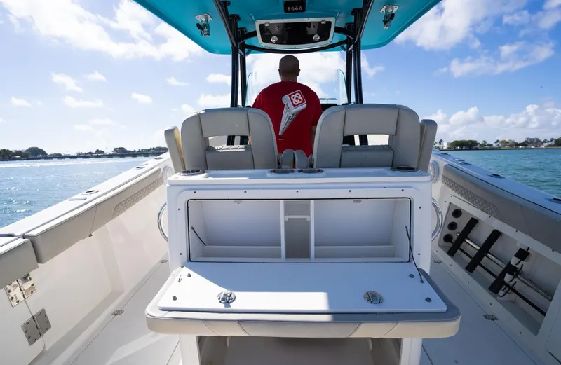  Yacht Photos Pics 2019 Century 3200 Center Console boat interior with person steering on open water.