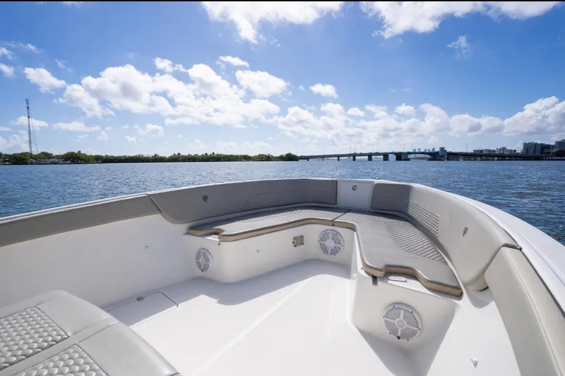  Yacht Photos Pics 2019 Century 3200 Center Console boat on water, clear sky, bridge in background.