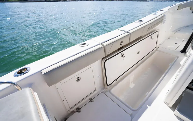  Yacht Photos Pics 2019 Century 3200 Center Console boat interior with storage compartments, on calm water.
