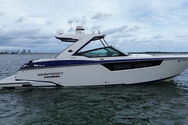 Viroque Yacht Photos Pics 2021 Monterey 378 Super Express boat on water, side view, cloudy sky background.