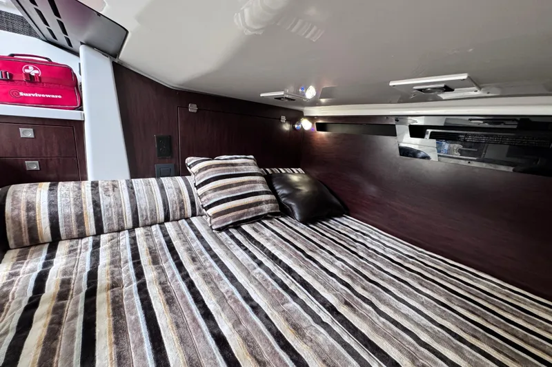 Viroque Yacht Photos Pics Luxurious cabin interior of 2021 Monterey 378 Super Express with striped bedding and cushions.