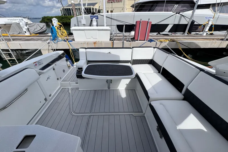 Viroque Yacht Photos Pics 2021 Monterey 378 Super Express boat interior with sleek seating and table at dock.