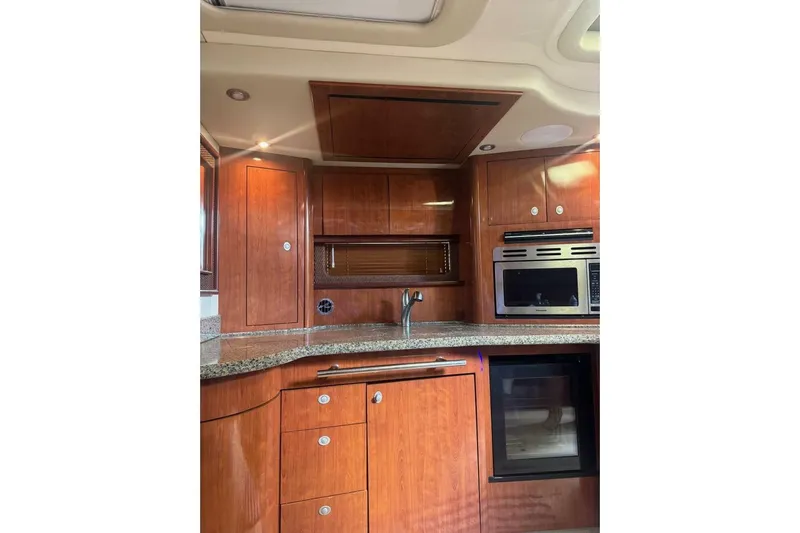 Patry-sea Yacht Photos Pics Luxurious 2005 Sea Ray 420 Sundancer yacht kitchen with wood cabinetry and modern appliances.