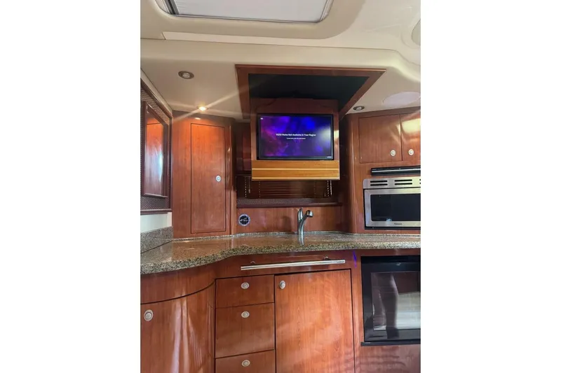 Patry-sea Yacht Photos Pics Luxurious 2005 Sea Ray 420 Sundancer yacht interior with wood cabinetry and modern appliances.