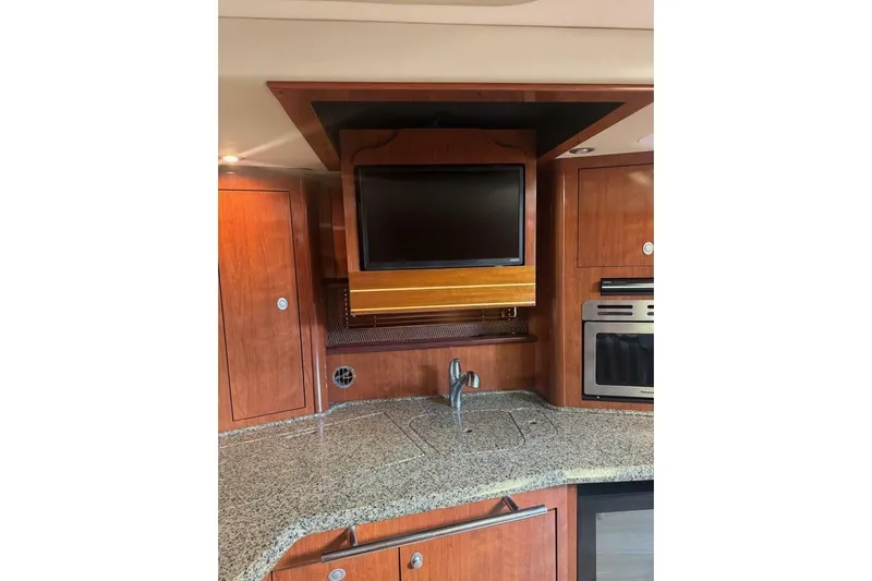 Patry-sea Yacht Photos Pics Luxurious 2005 Sea Ray 420 Sundancer yacht interior with TV and modern kitchen amenities.