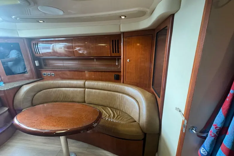 Patry-sea Yacht Photos Pics 2005 Sea Ray 420 Sundancer interior with curved leather seating and wooden cabinetry.