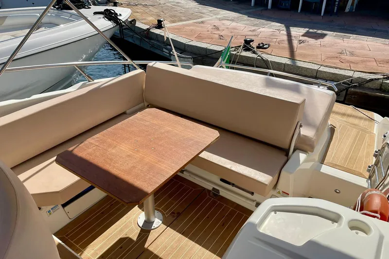  Yacht Photos Pics 2012 Cranchi Endurance 30 boat interior with beige seating and wooden table.