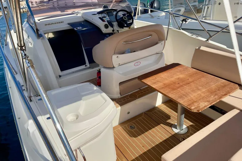  Yacht Photos Pics 2012 Cranchi Endurance 30 boat interior with helm, seating, and wooden table.