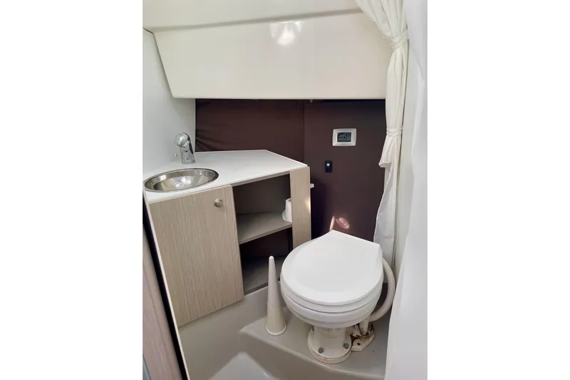  Yacht Photos Pics Cranchi Endurance 30 (2012) boat bathroom with sink, toilet, and storage cabinet.