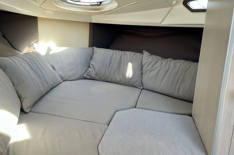  Yacht Photos Pics Cozy interior cabin of 2012 Cranchi Endurance 30 with plush gray cushions.