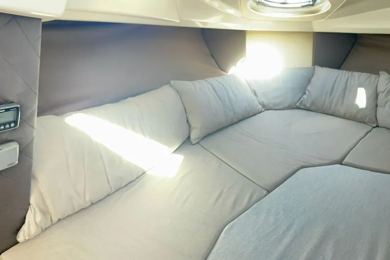  Yacht Photos Pics Interior cabin of 2012 Cranchi Endurance 30 with cushioned seating and sunlight.