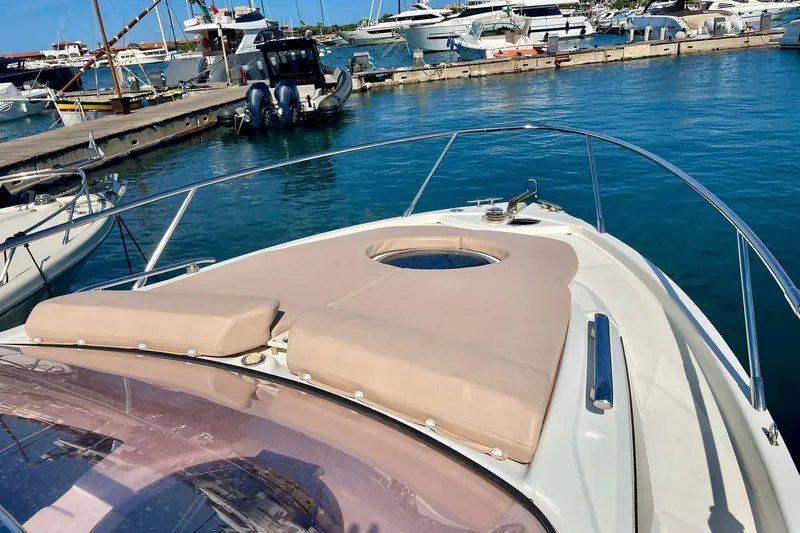  Yacht Photos Pics Cranchi Endurance 30 yacht, 2012 model, docked in a marina with sunbathing cushions.