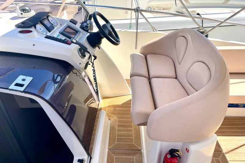  Yacht Photos Pics Cockpit of 2012 Cranchi Endurance 30 with steering wheel and beige seating.