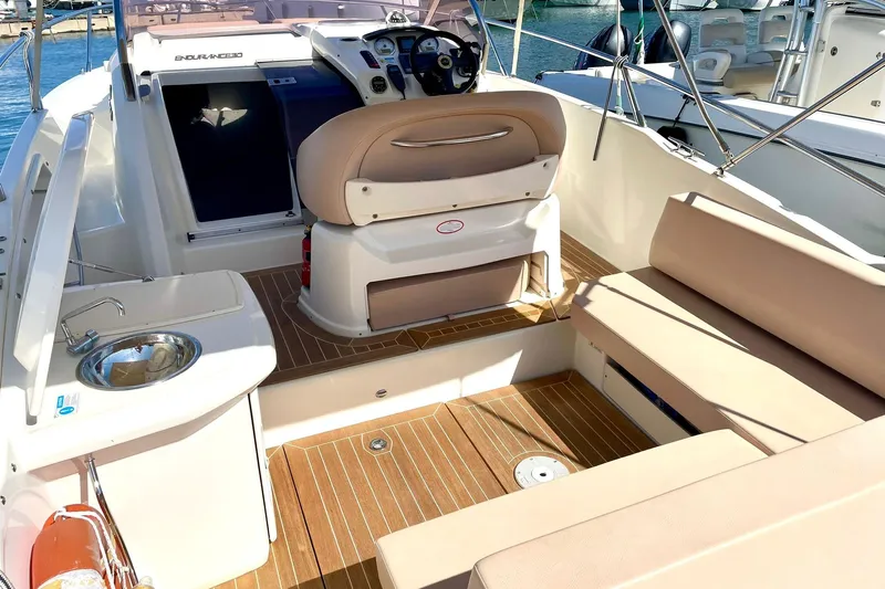  Yacht Photos Pics 2012 Cranchi Endurance 30 boat interior with seating, steering console, and sink.
