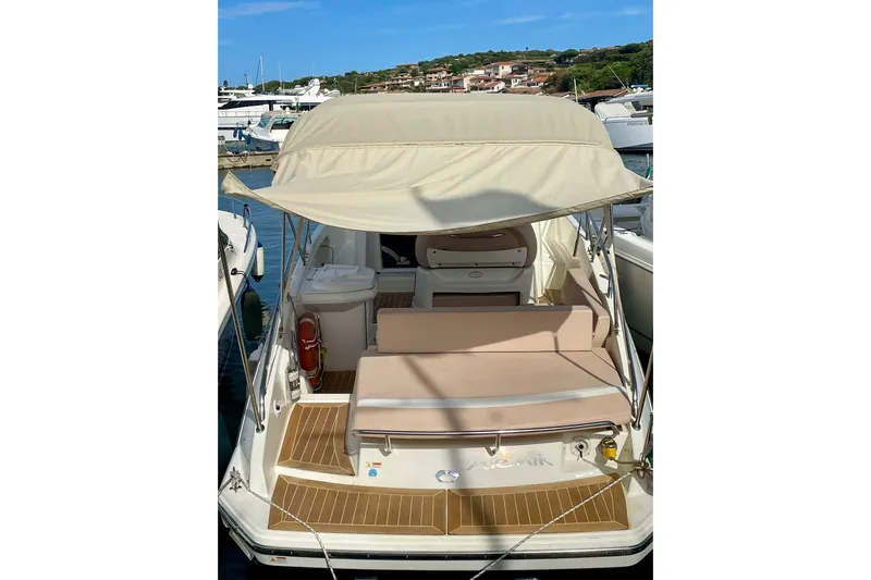  Yacht Photos Pics 2012 Cranchi Endurance 30 boat with canopy, docked in a marina.